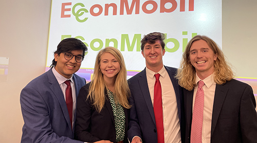 4 Neeley Fellows in front of EcconMobil presentation