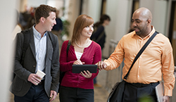 three students walking in Smith Hall