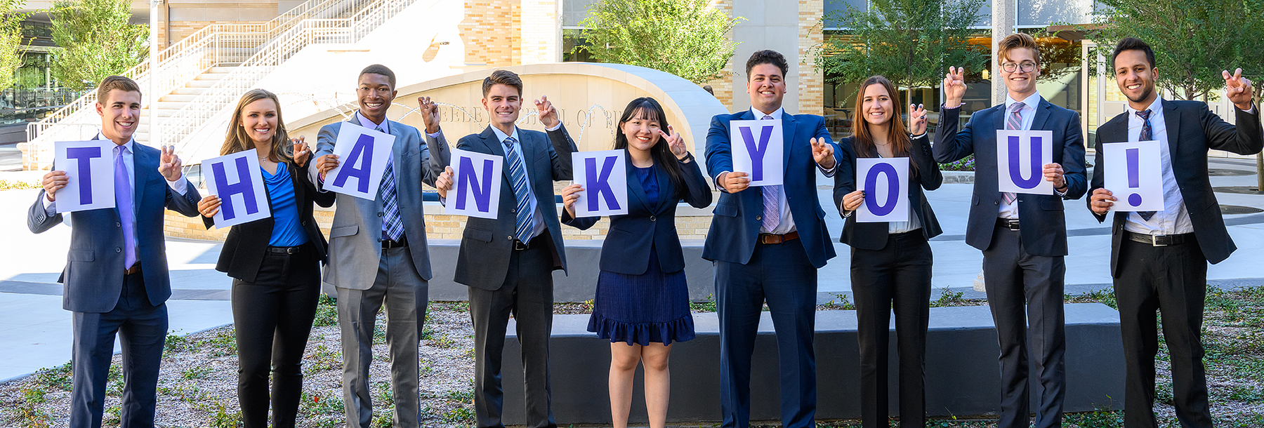 Section Image: Students at Neeley Fountain with cards spelling Thank You 