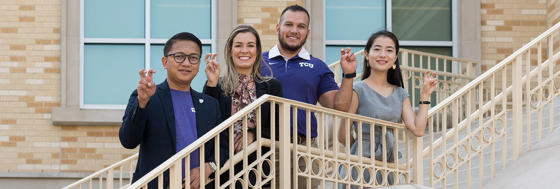 Section Image: Four alumni on the steps of the Neeley School 