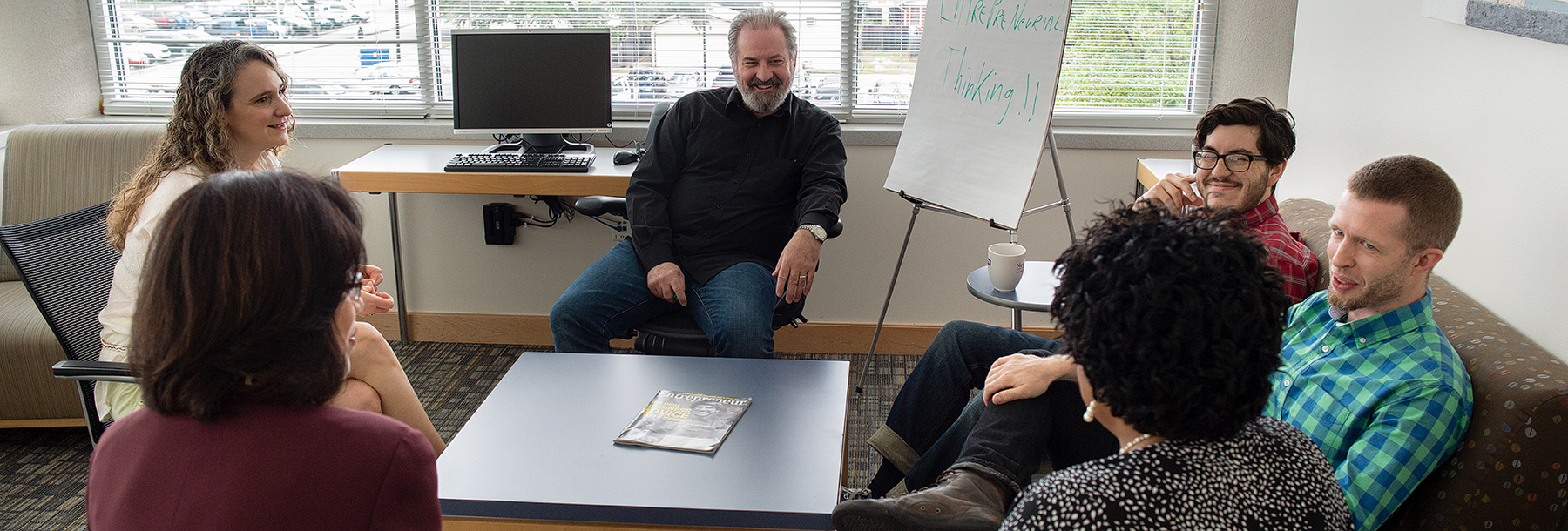 Section Image: A group sitting in a circle in Smith Hall. 