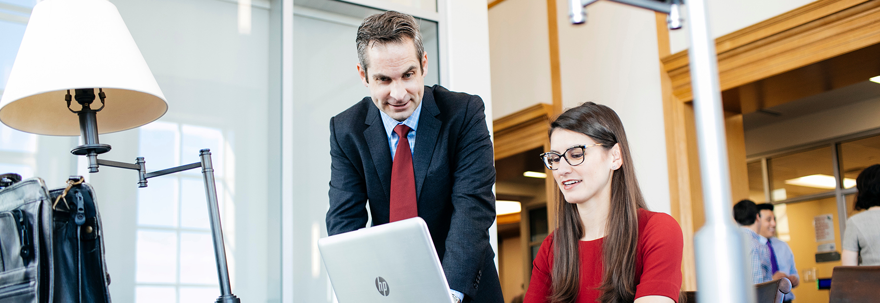 Section Image: Dr. Tyson Browning and female student looking at a laptop screen. 