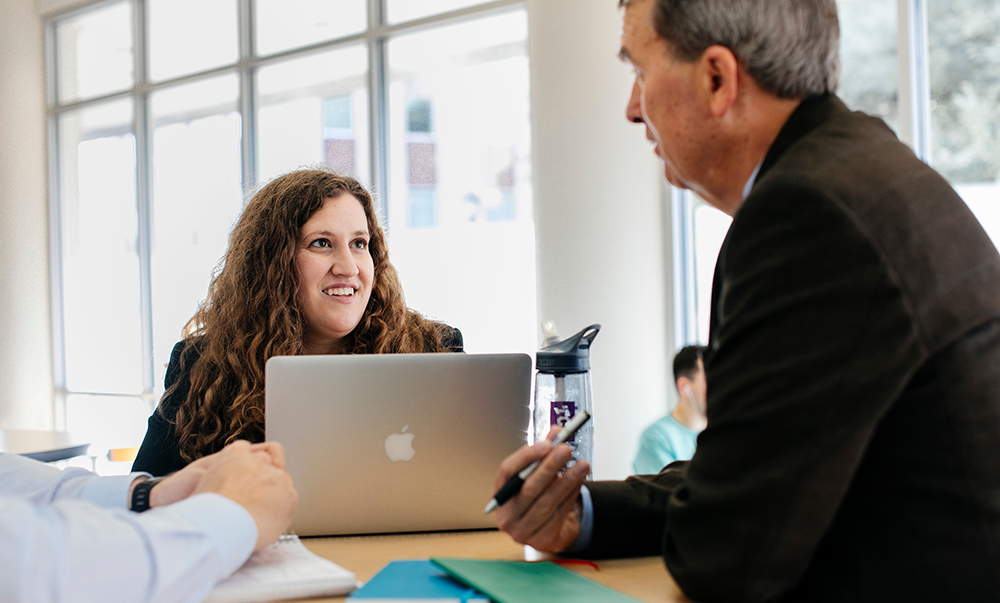 Bill Moncreif talking with a female student