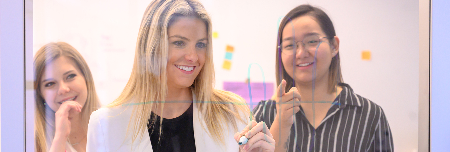 Section Image: three female students collaborating 