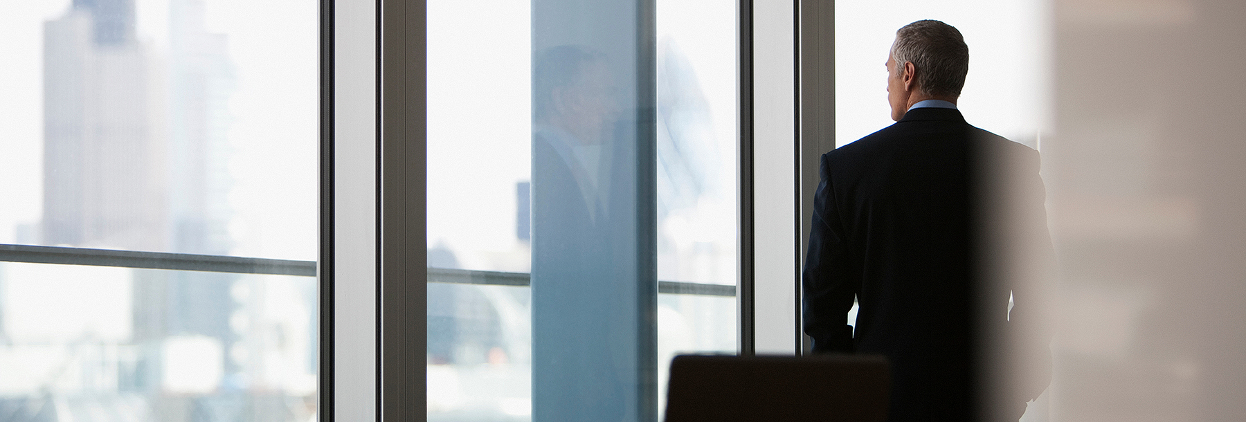 Section Image: Man standing at a window 