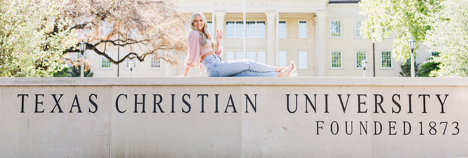 Section Image: Katrina Clough on the TCU sign 