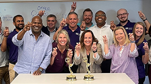 Gregg Lehman and the EMBA class celebrate the win of fellow Horned Frog Newy Scruggs.