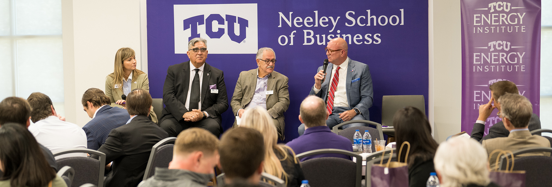 Section Image: Ann Bluntzer, Jonathan Benjamin-Alvarado, Manochehr Dorraj and Kenneth Wagner, the moderators and hosts of the event, address the crowd. 