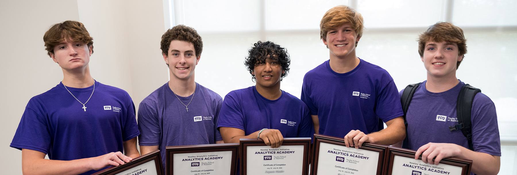 Section Image: Analytics Academy students display their certificates. 