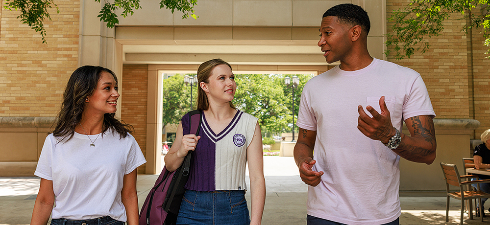 Section Image: Three students walking on campus 