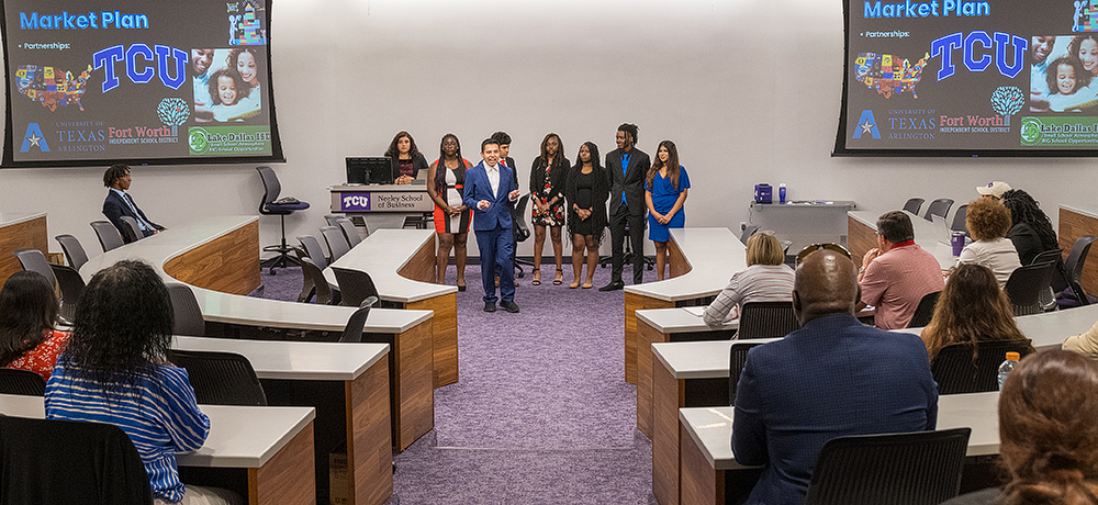 A group of students give a presentation in Neeley 1201