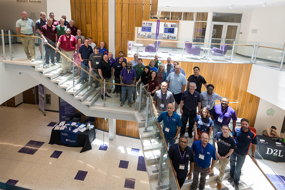 Technology in Business Schools conference attendees on the Grand Staircase in the Rogers Rotunda