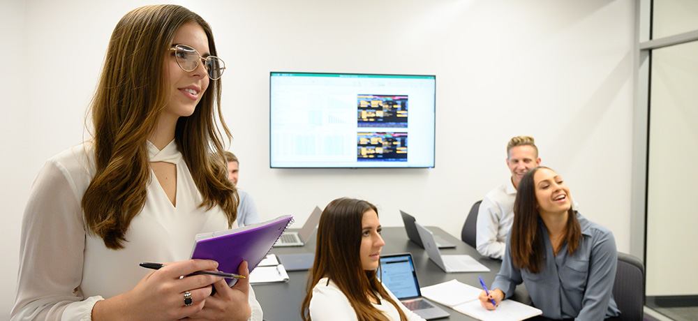 Section Image: Students collaborating in a team room 