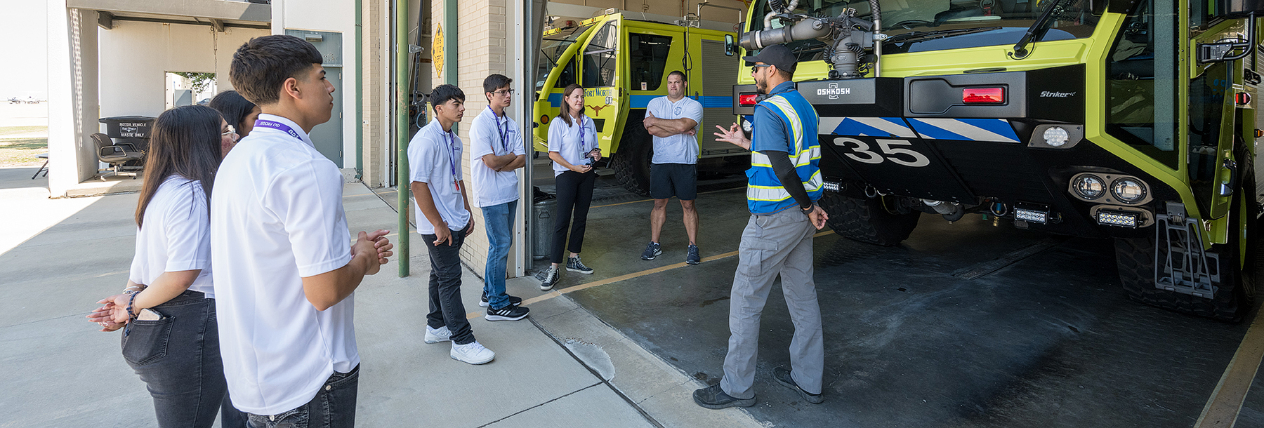 Section Image: Students on tour learning about equipment 