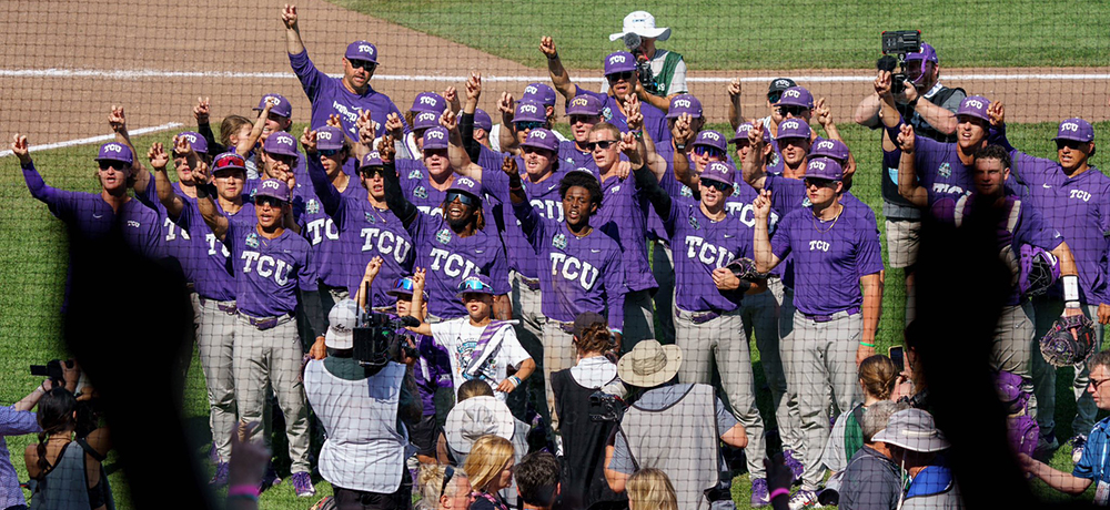 Baseball team on the field singing the alma mater