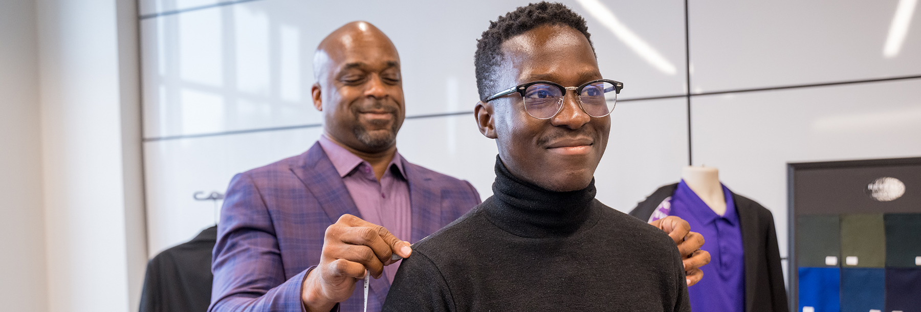 Section Image: Student being measured for a business suit 