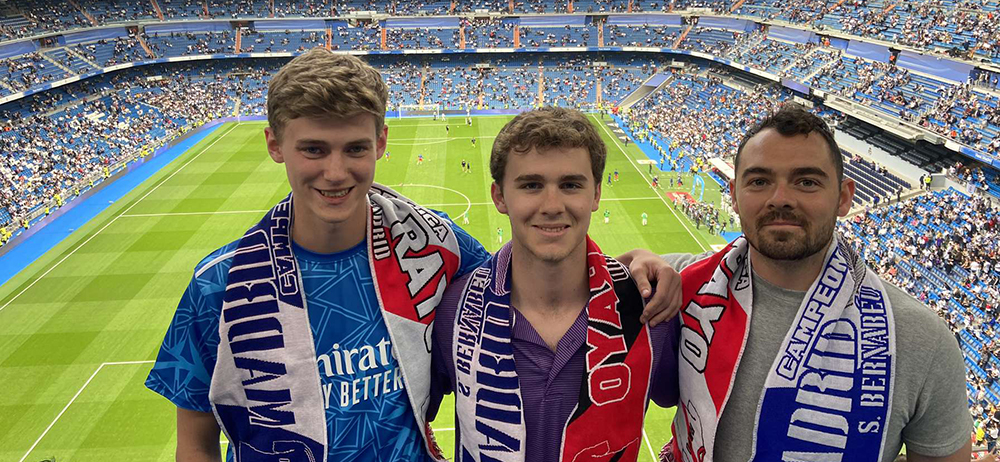 Matt and two other fellow students in the soccer stadium