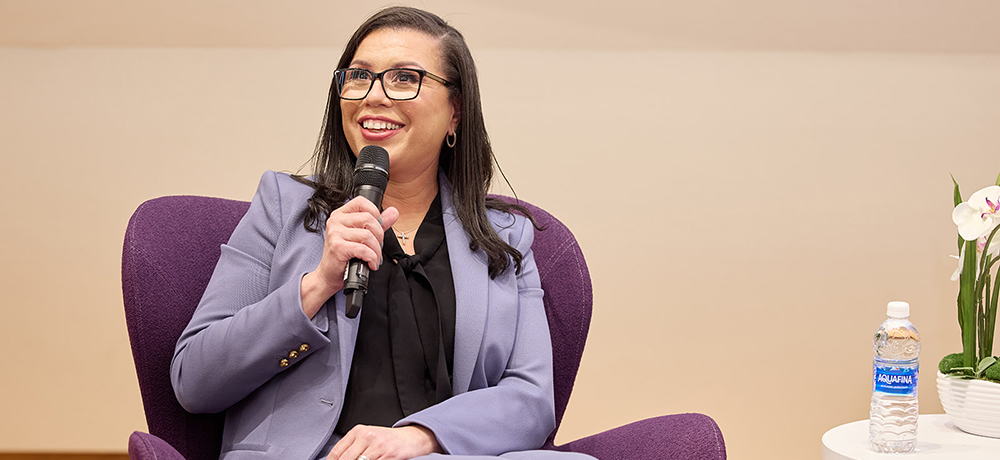 Section Image: Kalisha Holland with moderator Tracy Renee Williams on the stage of the Shaddock Auditorium 