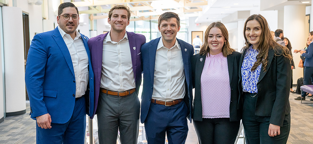 Section Image: Five students with arms around each other in Smith Hall 