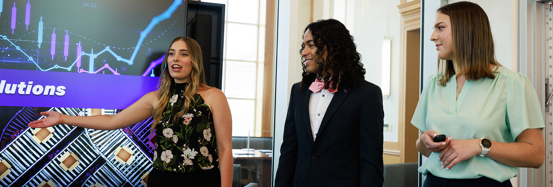 Section Image: Three students presenting in Rees Jones 