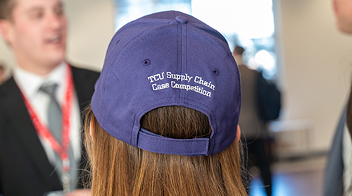 University of Wisconsin team of Tobias Kern, Sajal Dixit, Saurabh Papppu and Juhi Goenka at the Neeley fountain wearing purple competition baseball hats 