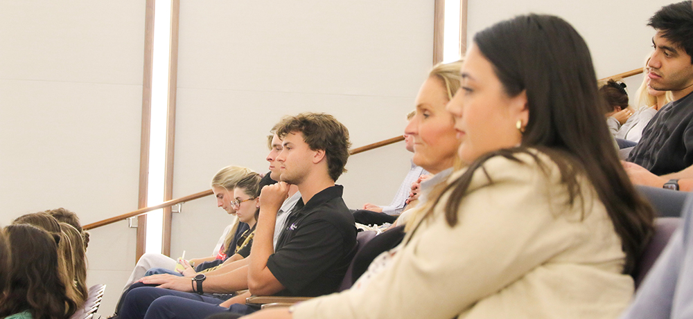 Audience members listening to Mayor Parker