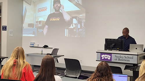 Section Image: Students and Professor Elijah Clark watch Super Bowl ads 