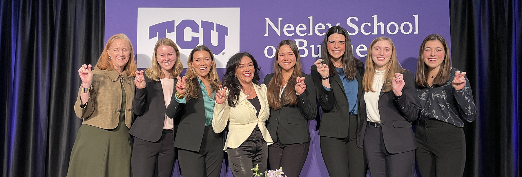 Section Image: A group Neeley Fellows women pose with a visiting speaker 