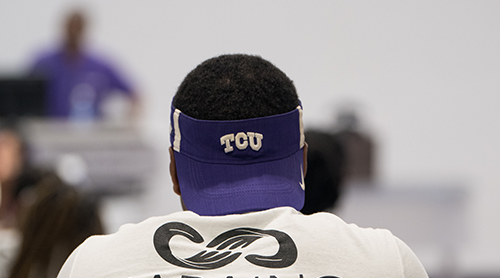 Section Image: Student wearing a TCU visor. 