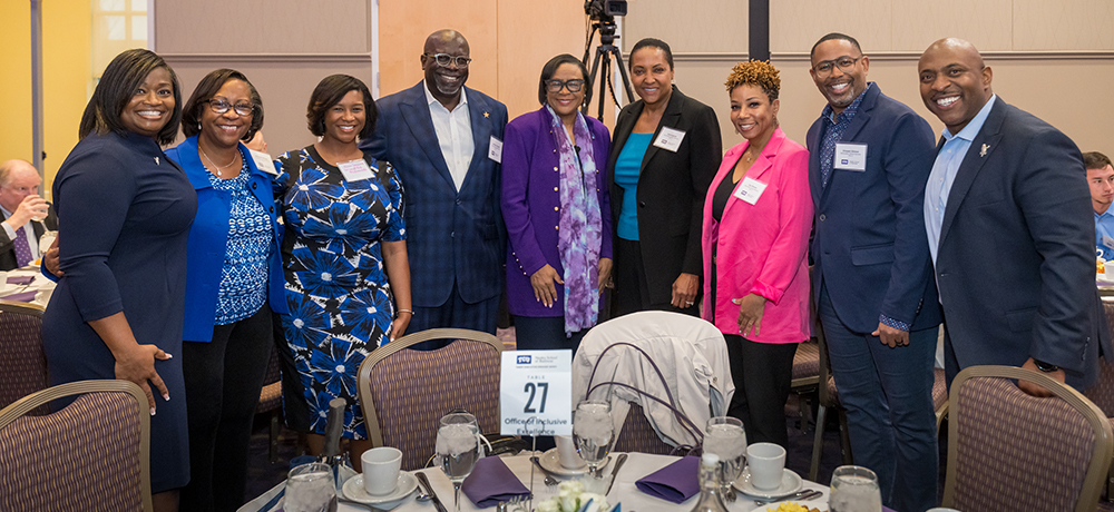 Group of leaders pose with Cynt Marshall