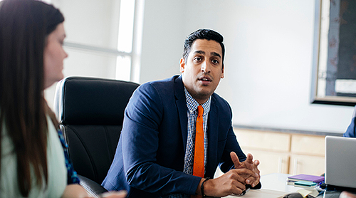 Man in suit and tie at a conference table