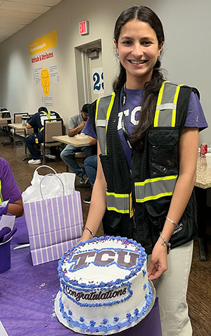 Maria Arguello with a cake that says TCU