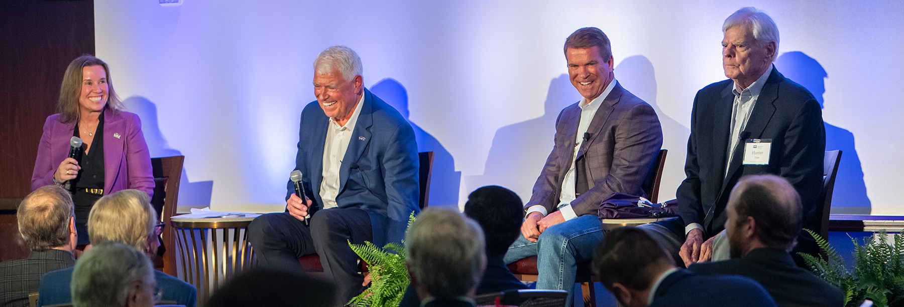 Section Image: Jennifer Engel and the three men from Four Sevens Oil on the stage at the 2024 Global Energy Symposium 