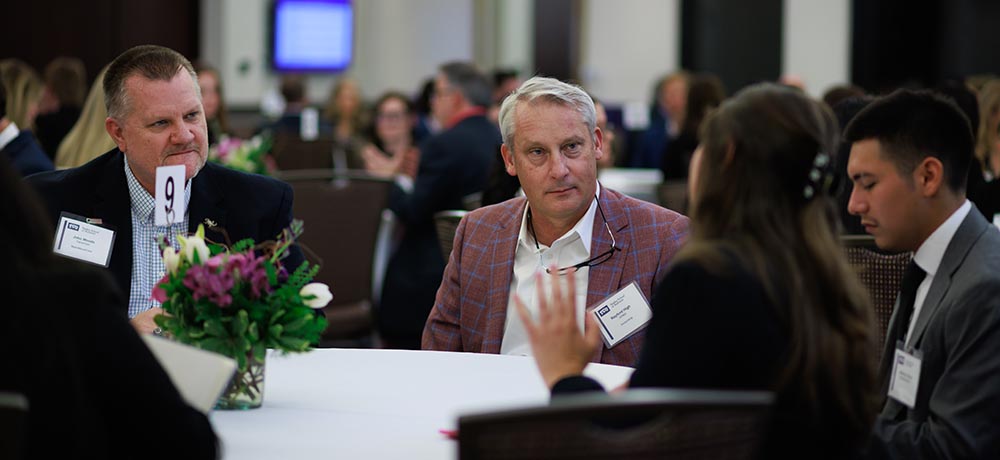 Mentors listen as students speak