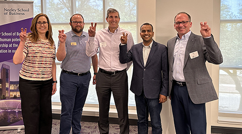 Section Image: TCU Accounting faculty and alumni with their "frogs up" 