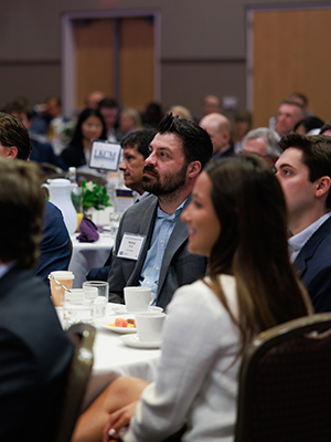 Audience members listening to Mike Freno