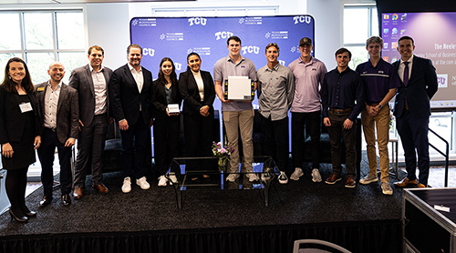 Section Image: Group of TCU students and faculty on the stage at the Bitcoin Mining Summit 