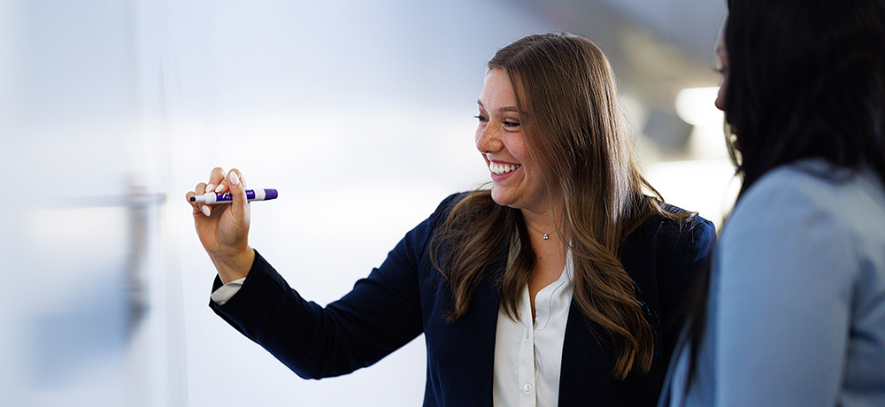 Section Image: Women at whiteboard with marker 