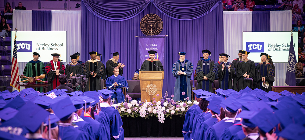 Professors on the platform with graduates