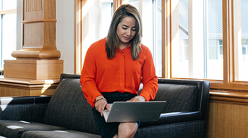 Girl in a red blouse with a laptop