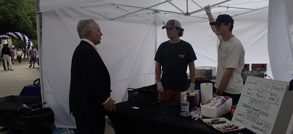Shaddock addresses the two student entrepreneurs in the Cheat Days Today tent