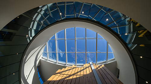 Student looking out the window of Smith Hall