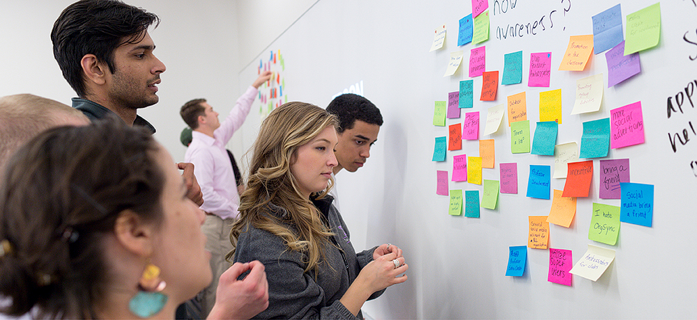 students with postit notes on a white board