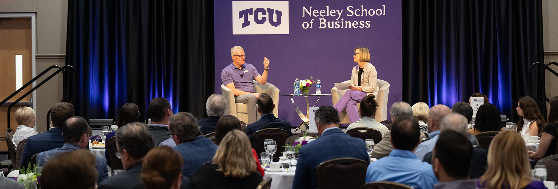 Section Image: Eric Artz and Hettie Richardson on the stage in the BLUU ballroom at the TESS event 