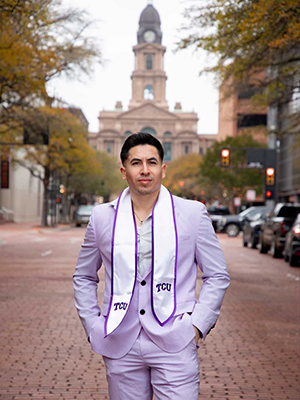 Adrian Peres in TCU graduation attire outside