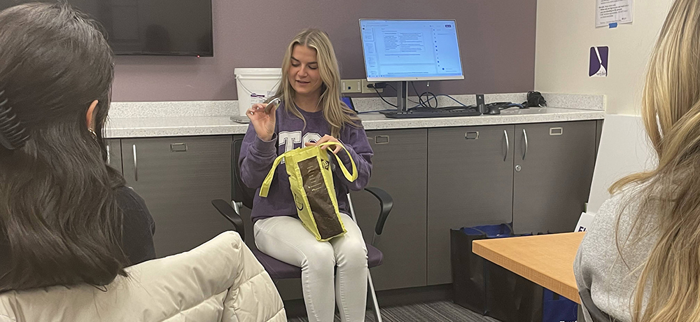 A student shows items from her bag to tell about herself.