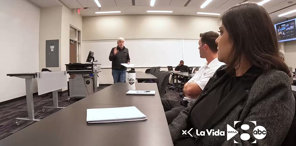 Maria Santos sits in class with Professor Tom Bates of the Energy MBA program