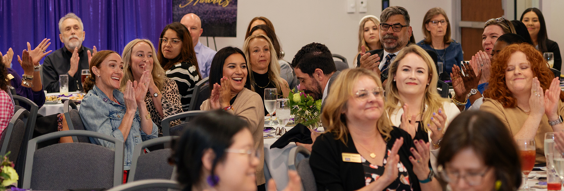 Section Image: Neeley awards audience members clapping for award recipient 