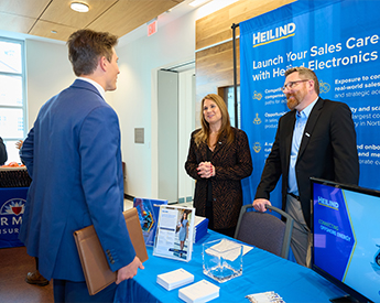 Student engaged with potential employer during sales recruiting event