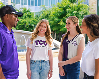TCU undergraduate students talking in front of Neeley fountain